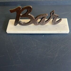 Metal BAR sign on marble like base
